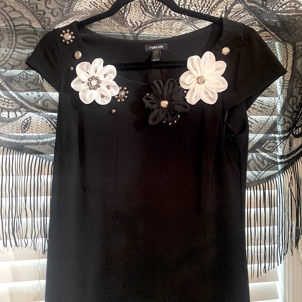 Gorgeous black dress with beautiful flowered neckline.